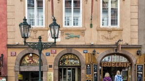 A historic building with ornate architectural details, including a prominent sign for 'TRDELNIK' and a decorative archway. - Maisonette 2 bedroom Apartment in the Heart of Prague (Prague)
