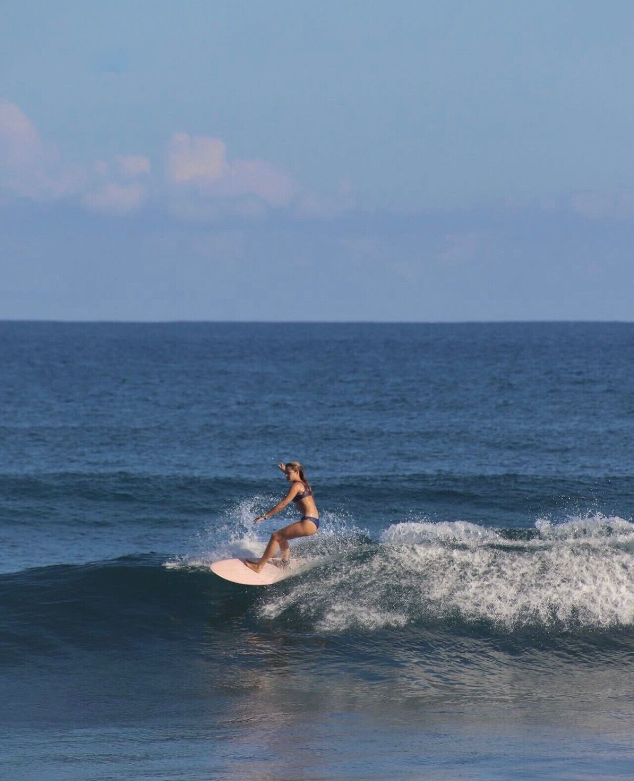 A person surfing on a wave in the ocean.