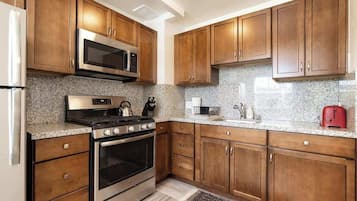 Fridge, coffee/tea maker, cookware/dishes/utensils