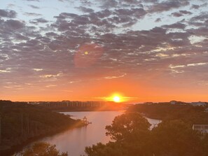 A sunset over a river with buildings in the background. - Crystal Blue Persuasion - 1BR/1BA Blue Mountain Beach Carriage House - Sleeps 2 (Santa Rosa Beach)