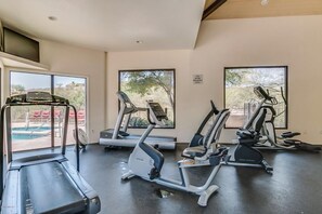 A gym with treadmills, elliptical machines, and a pool visible through the windows. - Vacation Near Sabino Canyon and Ventana Canyon Resort - Bikes Included! (Tucson)