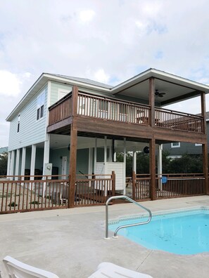 A two-story house with a balcony and a swimming pool. - Amazing sunsets and ocean breezes await you at this beautiful beach view home. (Port St Joe)