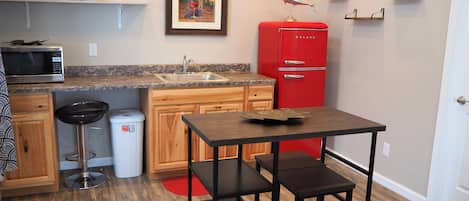 Fridge, microwave, cookware/dishes/utensils, dining tables
