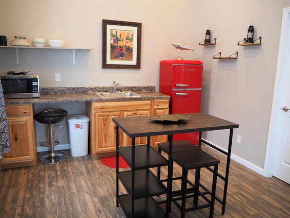 Fridge, microwave, cookware/dishes/utensils, dining tables