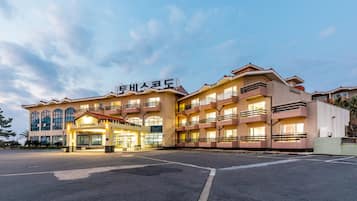 Welcome to our hotel, featuring a sleek glass facade and spacious balconies.