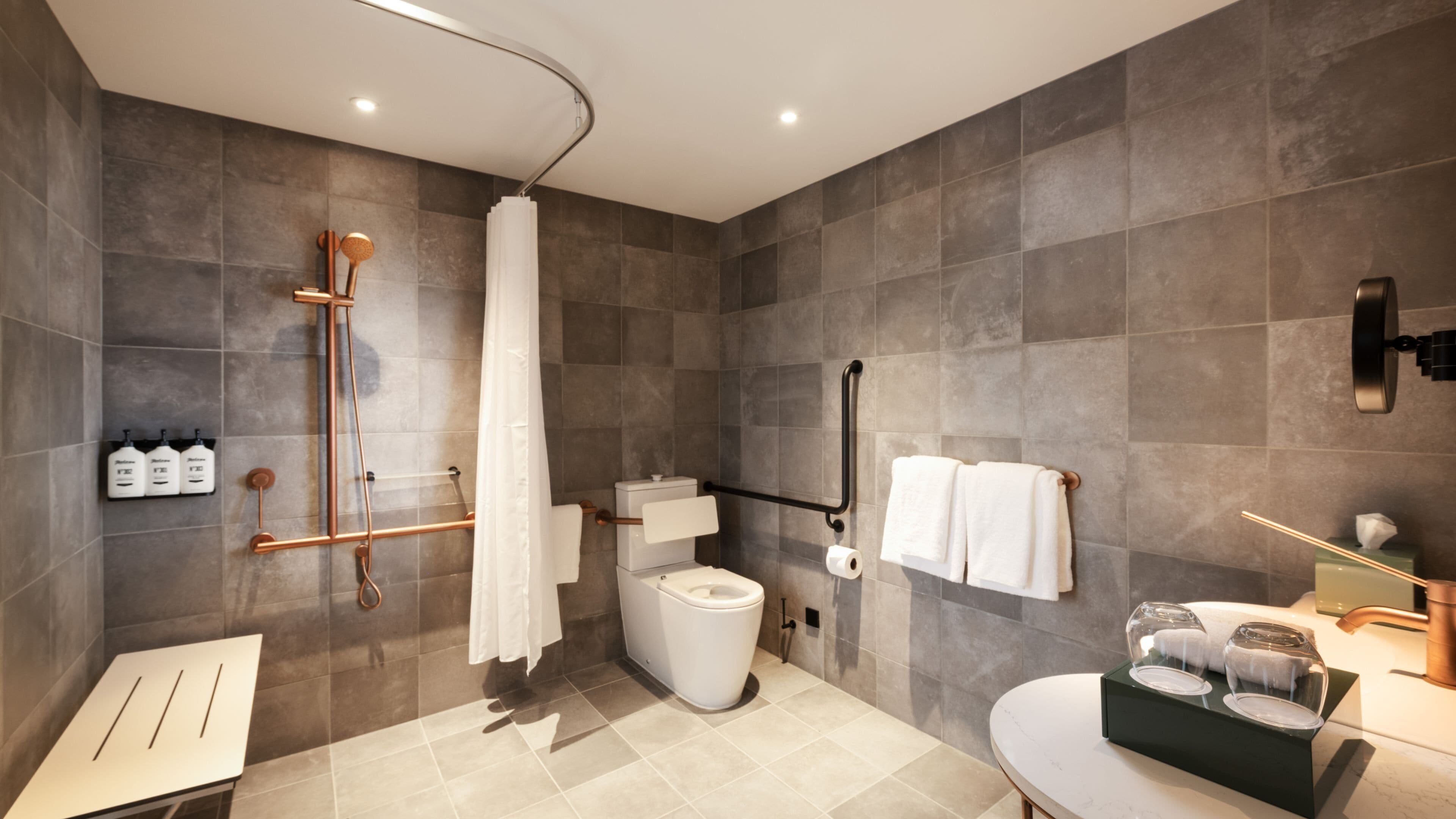 Un baño moderno con ducha, inodoro y lavamanos.