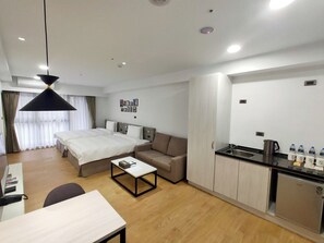 Relax in comfort with a large bed, sofa, and compact kitchenette.