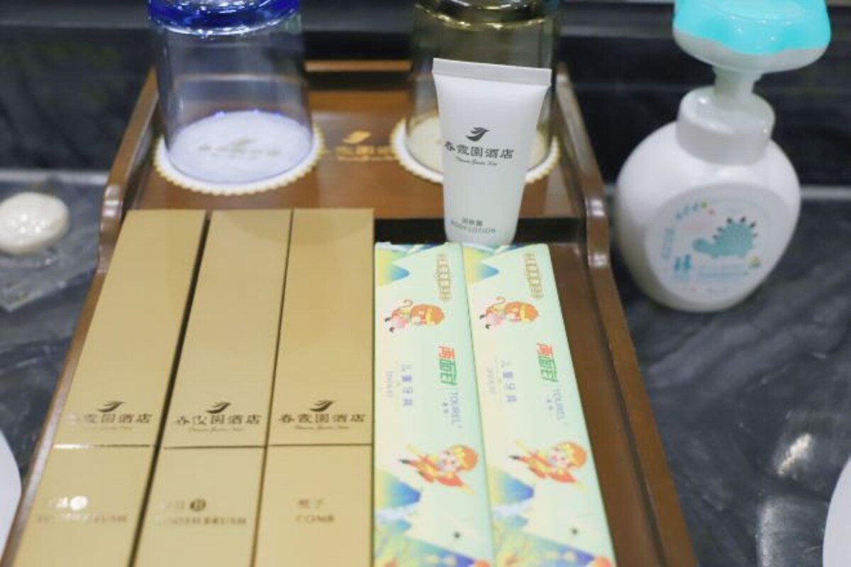 A tray with skincare products, a tube of cream, and several boxes on a marble surface.