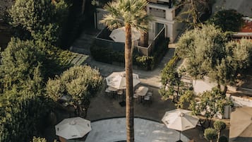 Seasonal outdoor pool, open 10:00 AM to 7:00 PM, pool umbrellas