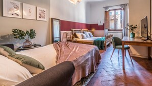 A bedroom with two beds, a desk, a chair, and a large window. - Wine Apartments Florence Franciacorta (Florence)