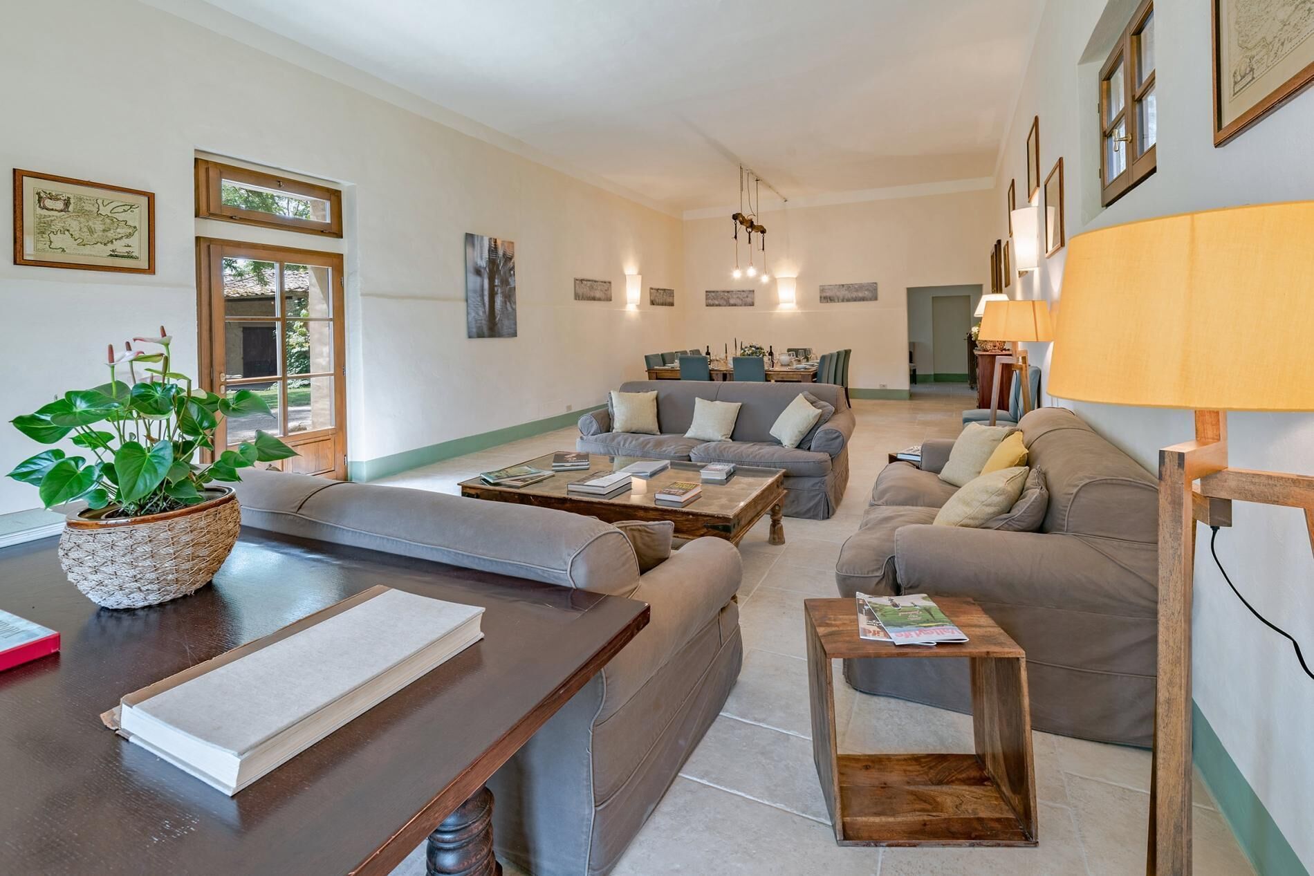 A living room with a sofa set, a coffee table, a side table, and a potted plant.