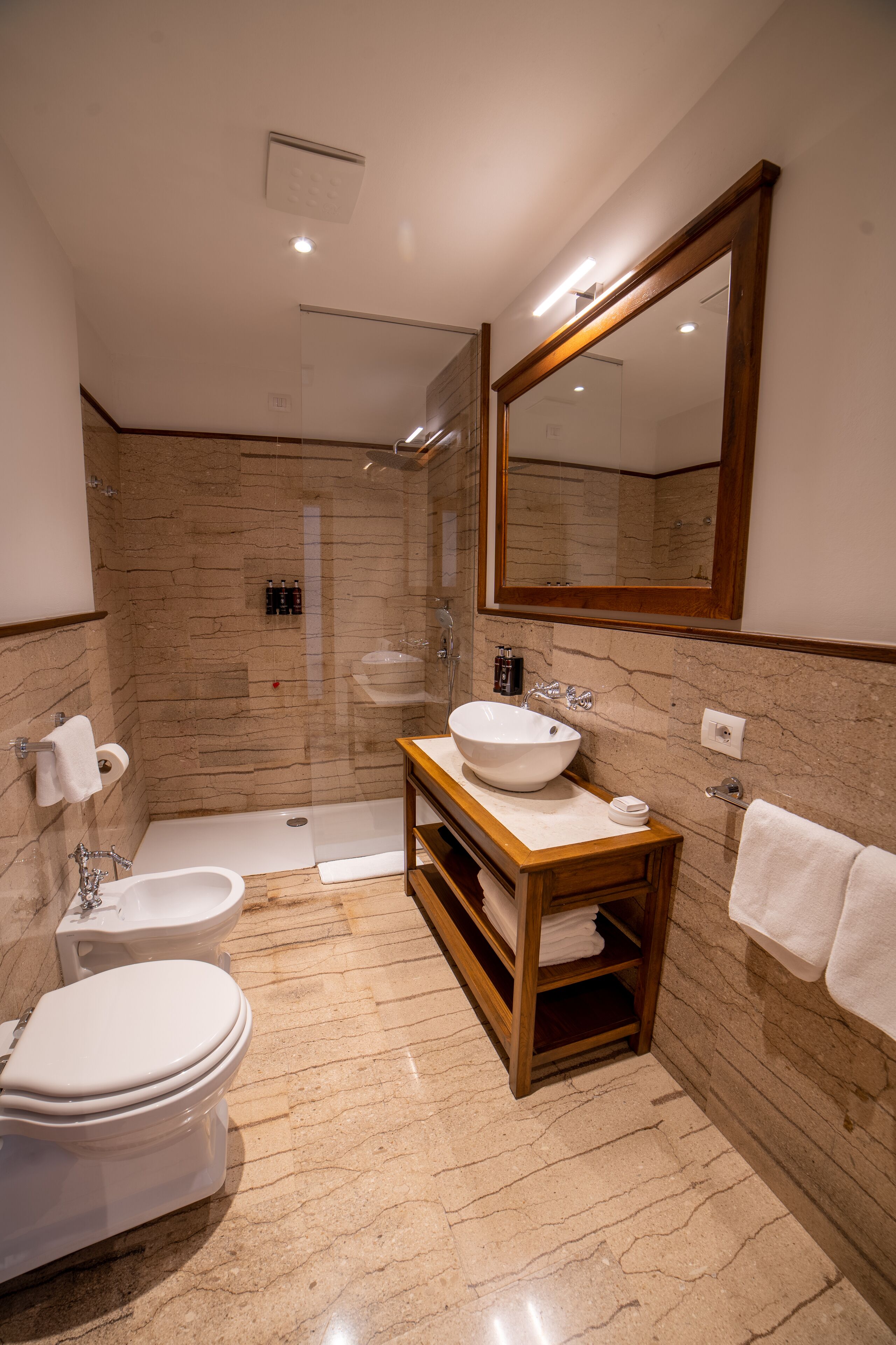 A modern bathroom with a bathtub, a sink, and a toilet.