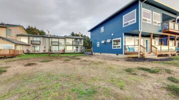 Una zona residencial con varias casas, incluyendo una casa azul con balcón y terraza de madera.