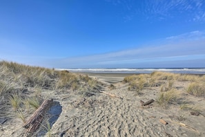 Enjoy the serene beach atmosphere with gentle waves and natural surroundings.