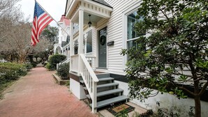 A white house with a front porch, a mailbox, and a mailbox number 414.