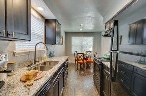 Fridge, stovetop, dishwasher, coffee/tea maker
