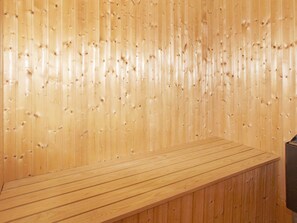 A wooden wall with evenly spaced vertical slats.