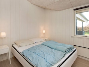 A bedroom with a bed, bedside lamps, and a window. - 8 Person Holiday Home in Borkop (Borkop)