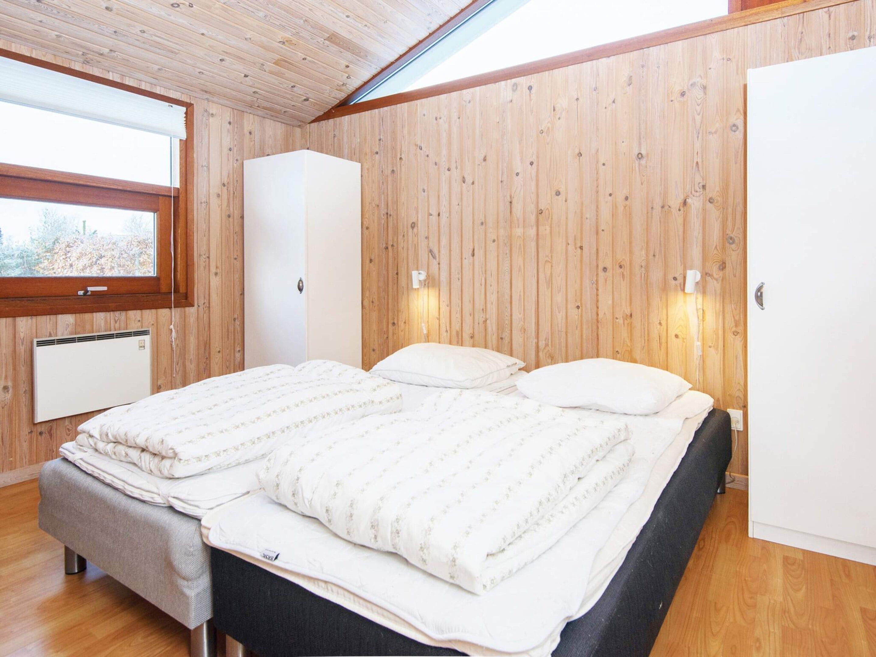A room with a bed, a wardrobe, and a radiator.