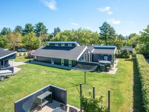 A modern house with a large patio, a garage, and a swimming pool. - Captivating Holiday Home in Ulfborg near Sea (Ulfborg)