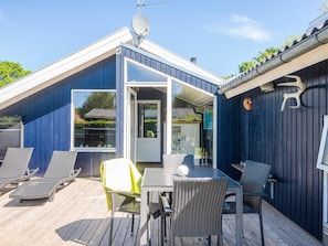 A modern house with a deck, a satellite dish, and outdoor furniture. - Captivating Holiday Home in Ulfborg near Sea (Ulfborg)