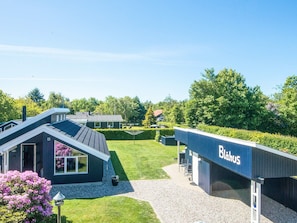A modern building with a sign reading 'Blahus' and a well-maintained lawn. - Captivating Holiday Home in Ulfborg near Sea (Ulfborg)