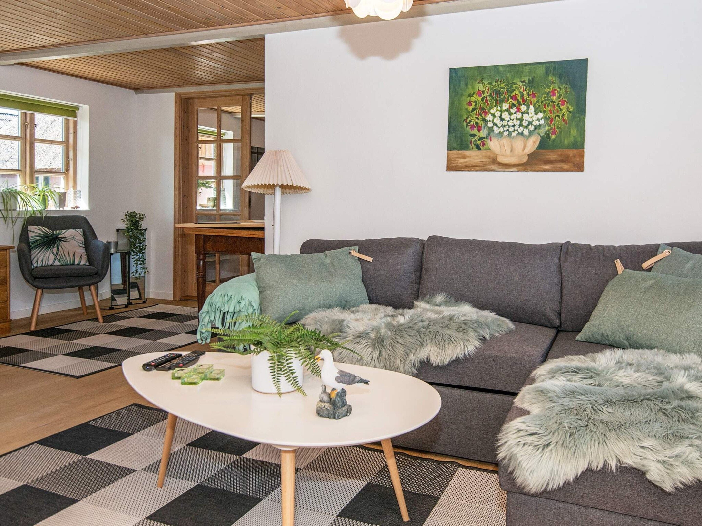 A modern living room with a sofa, a coffee table, and decorative items.