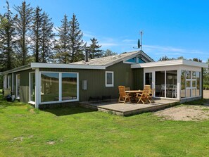 A modern cabin with a deck, large windows, and a satellite dish. - 4 Star Holiday Home in Hals (Hals)