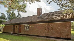 A brick building with a tiled roof, a chimney, and a sign that reads "Palletto". - 6 Person Holiday Home in NÃ¸rre Nebel (Norre Nebel)