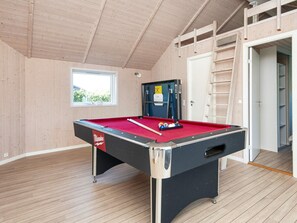A pool table in a room with wooden walls and a window. - 5 Star Holiday Home in Sydals (Sydals)