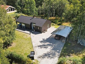 A modern house with a covered garage and a patio area.