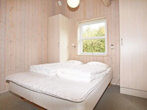 A room with a bed, a window, and wooden walls. - 4 Star Holiday Home in Tarm (Tarm)