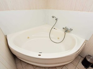 A white bathtub with a shower hose, a faucet, and a drain. - 8 Person Holiday Home in Oksbol-by Traum (Oksbol)