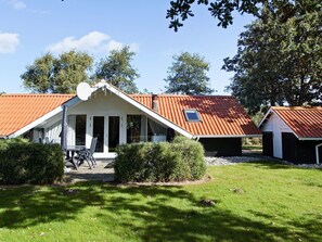 A residential building with a sloped roof, a covered porch, and a satellite dish. - 6 Person Holiday Home in Hemmet (Hemmet)