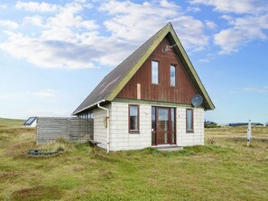 A small, single-story building with a sloped roof, a satellite dish, and a number '6' on the side. - Scenic Holiday Home in Harboøre near Sea (Harboore)