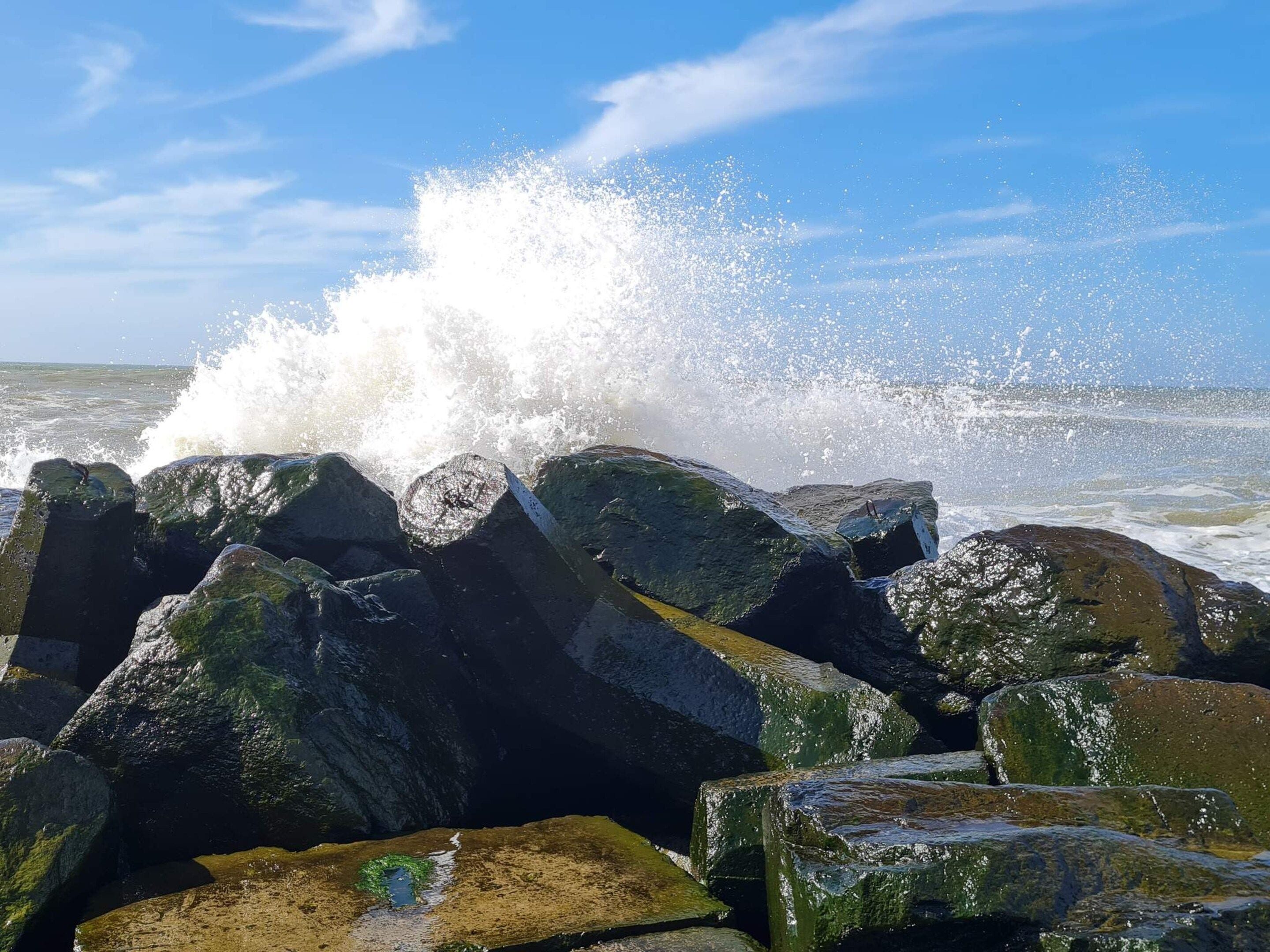 A rocky shoreline with waves crashing against the rocks.