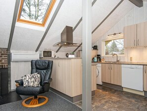 A modern kitchen with a skylight, a built-in microwave, and a Bosch dishwasher.