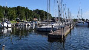 A marina with multiple boats docked along a wooden pier. - Cozy Holiday Home in Hadsund near Family Friendly Beach (Hadsund)