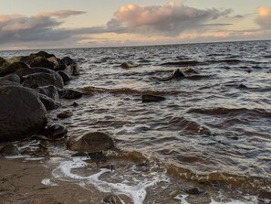 A rocky shoreline with waves crashing against the rocks. - 8 Person Holiday Home in Tarm (Tarm)