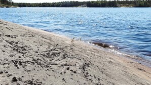 A beach with a sandy shore and calm water. - 5 Person Holiday Home in Logdea (Lögdeå)