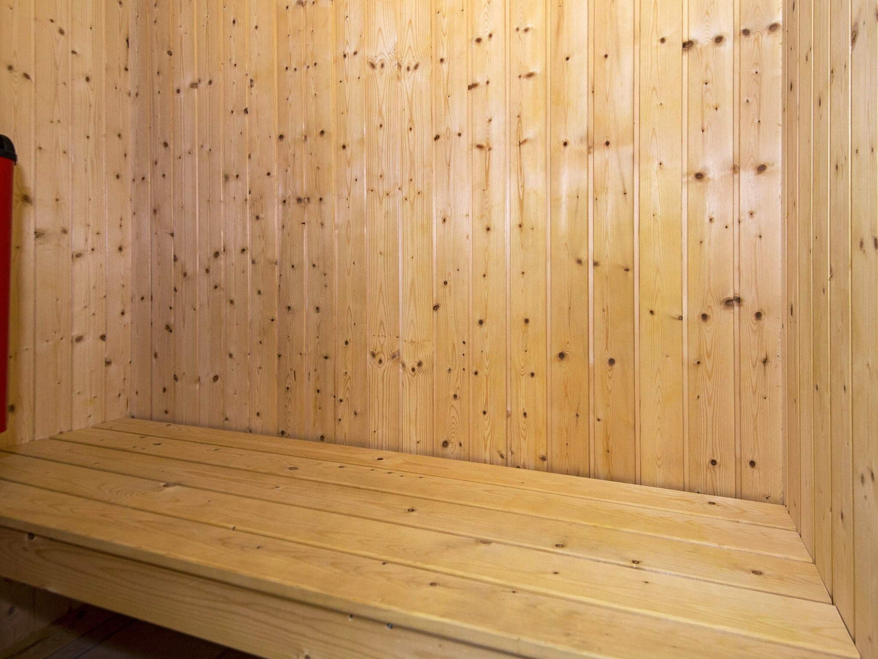 A wooden interior with a bench.