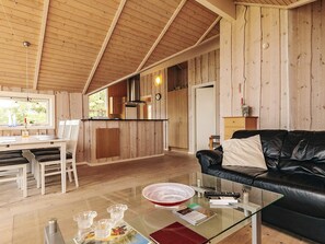 A cozy cabin interior with a dining area, kitchen, and living space. - 5 Star Holiday Home in Vestervig (Vestervig)
