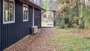 Eine Holzhütte mit Fenster und einer Klimaanlage außen.