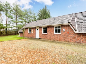 A brick building with a tiled roof, a front door, and two windows. - 4 Star Holiday Home in Oksbol (Oksbol)