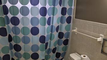 Combined shower/bathtub, towels, toilet paper