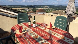 A table set outdoors with a view of the countryside. - 13th Century Townhome (Monflanquin)
