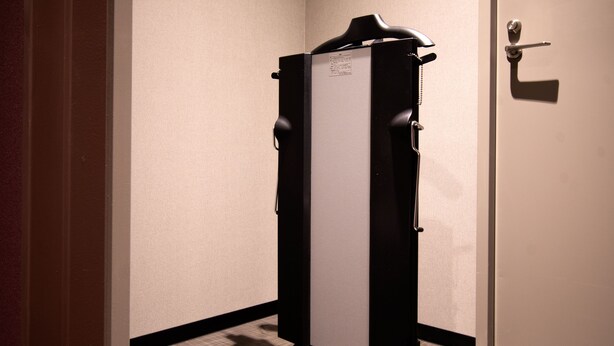 A compact, modern elevator in a hotel room with a simple design and a small control panel. - HIYORI HOTEL OSAKA SHINSEKAI (Osaka)