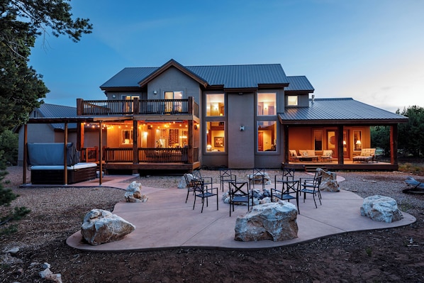 Enjoy a view of the surrounding landscape from the upper-level balcony, or relax in the covered patio area with outdoor seating.