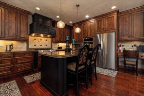 Enjoy cooking in this well-equipped kitchen with a central island, double ovens, and microwave.