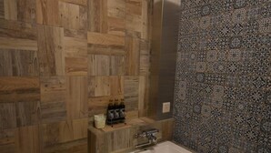 A modern bathroom with a wooden floor and a patterned tile wall. - Hotel Keypoint - Adults Only (Kai)